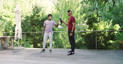 Two Men Enjoying Outdoor Hydration and Friendship