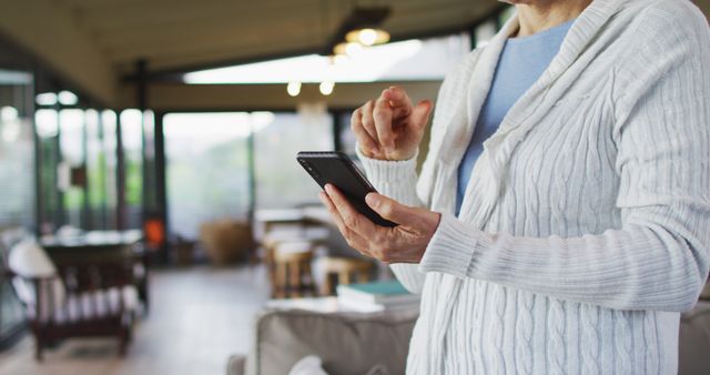 Senior woman using smartphone at home for staying connected - Download Free Stock Images Pikwizard.com