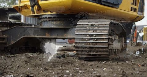 Excavator undercarriage with worn track assembly on muddy construction site inspection