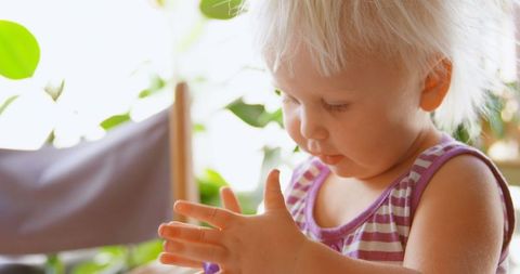 Curious Baby Engaging with Colorful Clay at Home