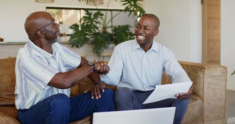 Smiling Businessman Shaking Hands During Successful Meeting