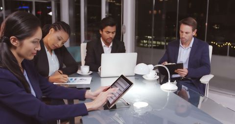 Diverse Professionals in Night Meeting Collaborate on Tasks - Download Free Stock Images Pikwizard.com