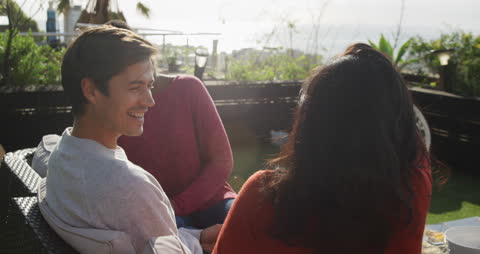 Friends Relaxing on Rooftop Terrace on Cloudy Day