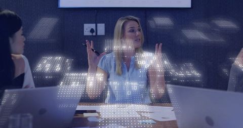 Female Executive Leading Data-Driven Meeting with Holographic Data Overlay
