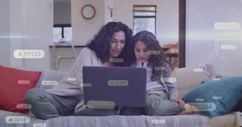 Parent and child learning together on laptop at home cozy sofa family bonding and technology