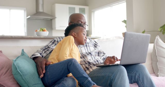 Grandfather and Grandson Relaxing with Laptop on Couch - Download Free Stock Images Pikwizard.com