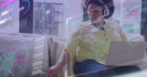 African American Businesswoman Analyzing Data on Multiple Screens