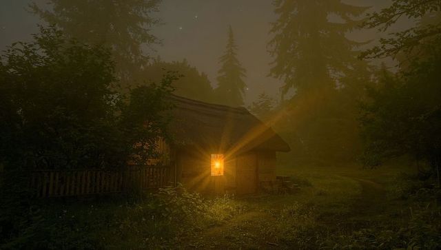 Foggy Forest Cabin with Warm Glowing Window Light in Twilight Clearing Rustic Wooden Hut