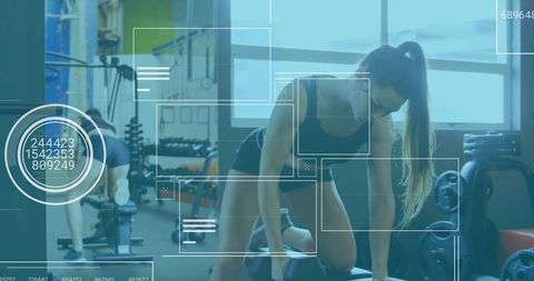 Woman Performing One-Arm Dumbbell Row in Modern Gym