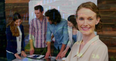 Smiling Businesswoman with Team Analyzing Financial Data