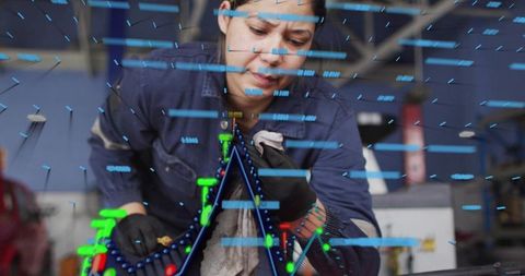 Female mechanic cleaning engine with augmented reality diagnostics in garage workshop