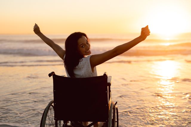 This image captures a disabled woman in a wheelchair enjoying a beautiful sunset on the beach with her arms outstretched. It can be used for promoting inclusivity, empowerment, and positivity. Ideal for websites, blogs, and campaigns focused on disability awareness, travel, and outdoor activities.