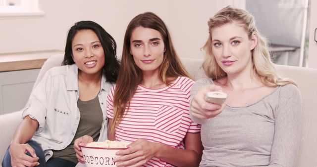 Three Young Women Watching Movie and Eating Popcorn on Sofa - Download Free Stock Images Pikwizard.com