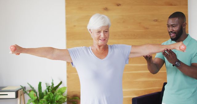 Elderly Woman Exercising with Weights Under Trainer's Supervision - Download Free Stock Images Pikwizard.com