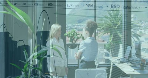 Businesswomen collaborating in modern fintech office