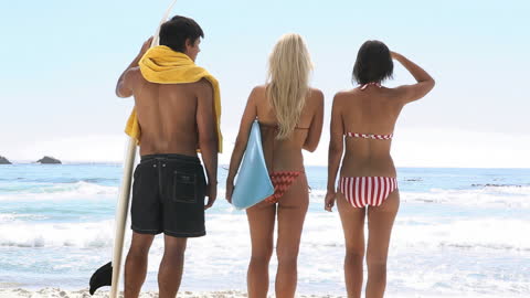 Friends Enjoying Sunny Beach Day with Surfboard