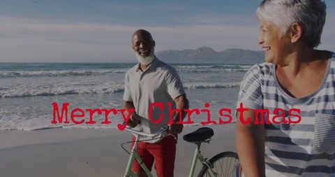 Senior Couple Enjoying Christmas by the Beach with Bicycles