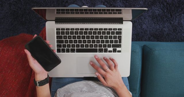 Overhead View of Person Using Laptop and Smartphone on Sofa - Download Free Stock Images Pikwizard.com