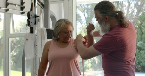 Senior Couple Engaged in Home Gym Resistance Band Workout