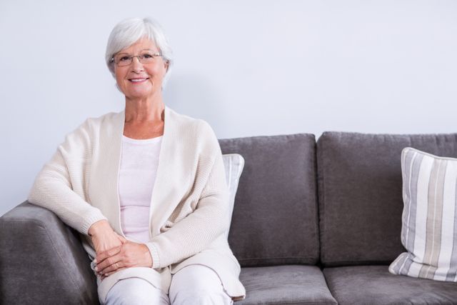 Portrait of senior woman sitting on sofa in clinic