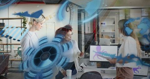 Collaborating women in modern office reviewing holographic data visualizations and tech