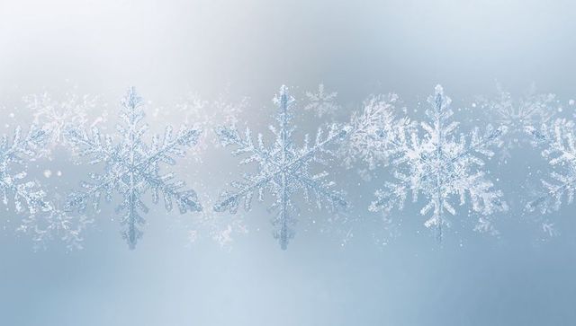 Row of symmetric pale crystal snowflakes on soft blue gradient with sparkling frost and bokeh