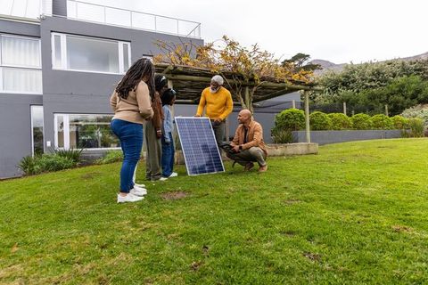African american family learning about residential solar installation in front yard
