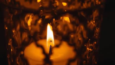 Flickering Candle Flame in Decorative Holder Creating Cozy Atmosphere