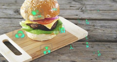 Gourmet cheeseburger with floating ar icons on rustic cutting board for food tech ads