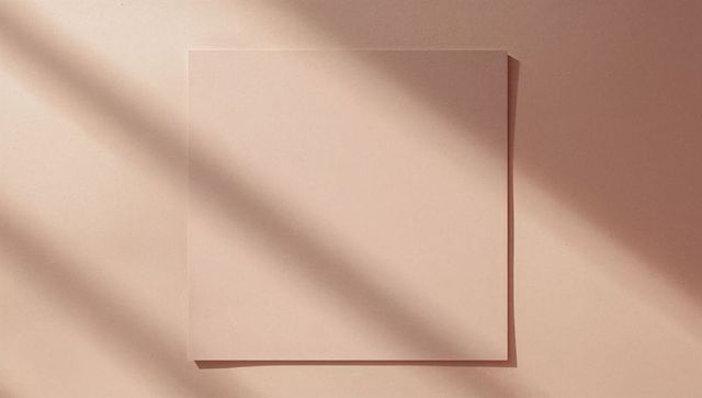 Minimalist square sheet with soft shadows on neutral beige surface