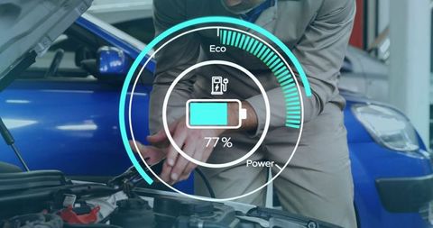 Technician connecting car battery with digital charge gauge showing 77% eco power