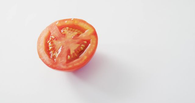 Image of fresh halved red tomato with copy space on white background. fusion food, fresh vegetables and healthy eating concept.