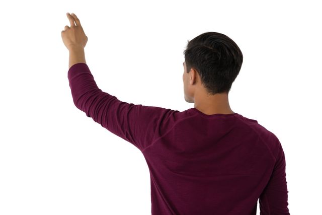 Businessman standing with back turned, touching an invisible screen. Ideal for use in technology, business, and virtual interface design concepts. Suitable for presentations, websites, and promotional materials focused on modern technology and interactive environments.
