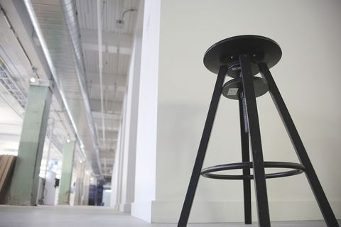 Industrial Studio Interior with Sleek Black Metal Bar Stool