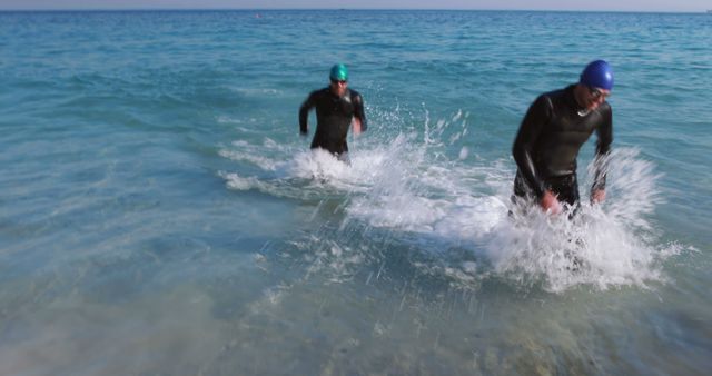 Athletes Emerging from Water After Triathlon Swim Segment in Wetsuits - Download Free Stock Images Pikwizard.com