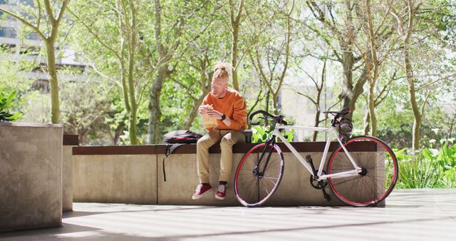 Young Man Relaxing Outdoors, Browsing Smartphone by Bicycle - Download Free Stock Images Pikwizard.com