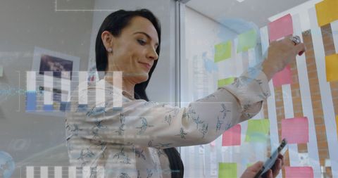 Businesswoman Organizing Sticky Notes with Digital Tablet