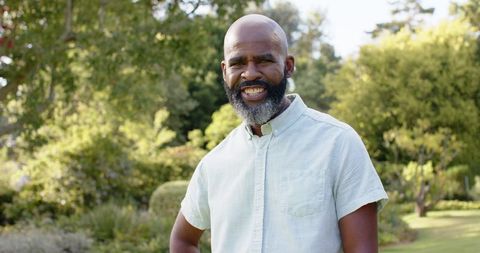 Smiling man enjoying nature in lush garden outdoors
