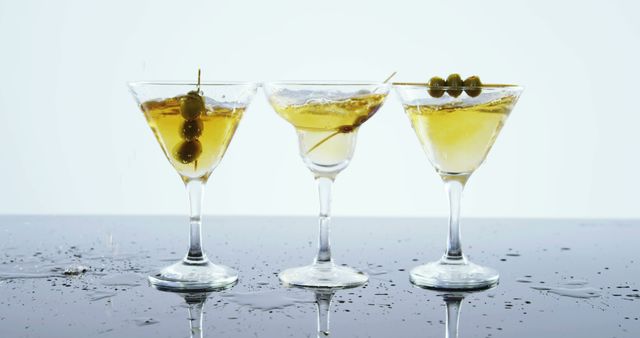 Three Martini Glasses with Olives on Reflective Surface - Download Free Stock Images Pikwizard.com