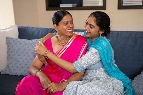 Indian Mother and Daughter Sharing Intimate Embrace on Couch