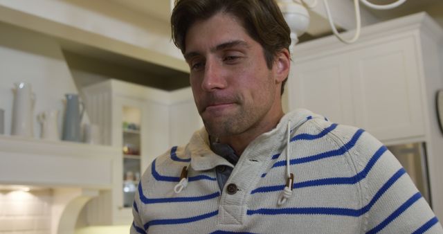 Contemplative Young Man in a Cozy Kitchen - Download Free Stock Images Pikwizard.com