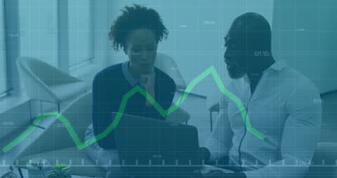 Diverse Business Team Analyzing Financial Graphs in Office