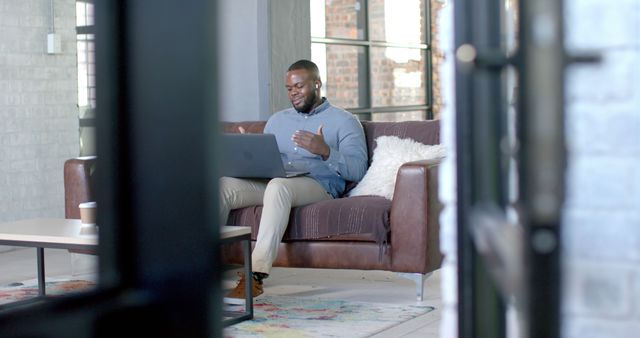 Happy man having virtual meeting in modern living room - Download Free Stock Images Pikwizard.com