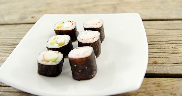 Delicious Sushi Rolls on White Plate for Culinary Insight - Download Free Stock Images Pikwizard.com