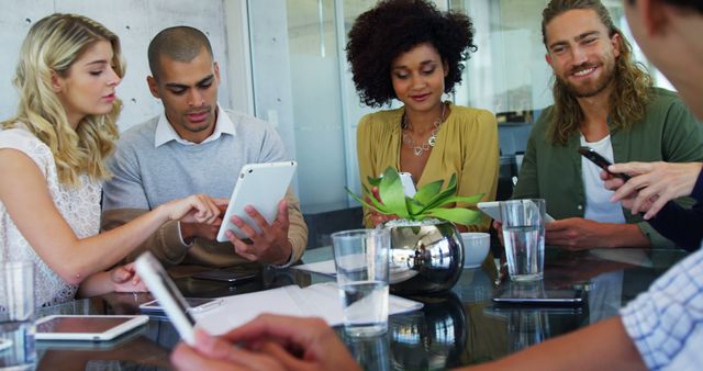 Diverse Team Collaborating Around Office Table - Download Free Stock Images Pikwizard.com