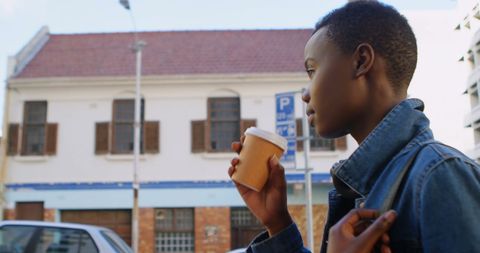 Young Woman Enjoying Coffee in Urban Surroundings