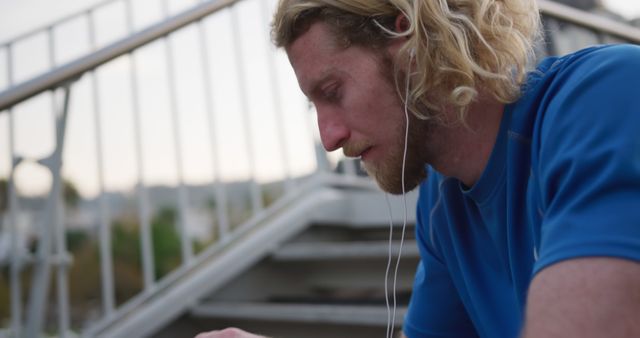 Man with Earphones Resting After Exercise Outdoor - Download Free Stock Images Pikwizard.com