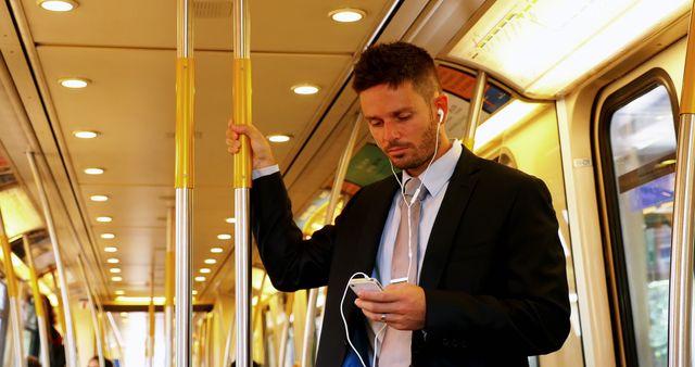 Businessman listening to music during subway commute - Download Free Stock Images Pikwizard.com