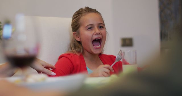 Excited Girl Enjoying Meal at Family Dinner - Download Free Stock Images Pikwizard.com