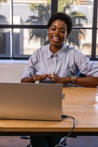 Cheerful African American Woman Engaging in Online Meeting